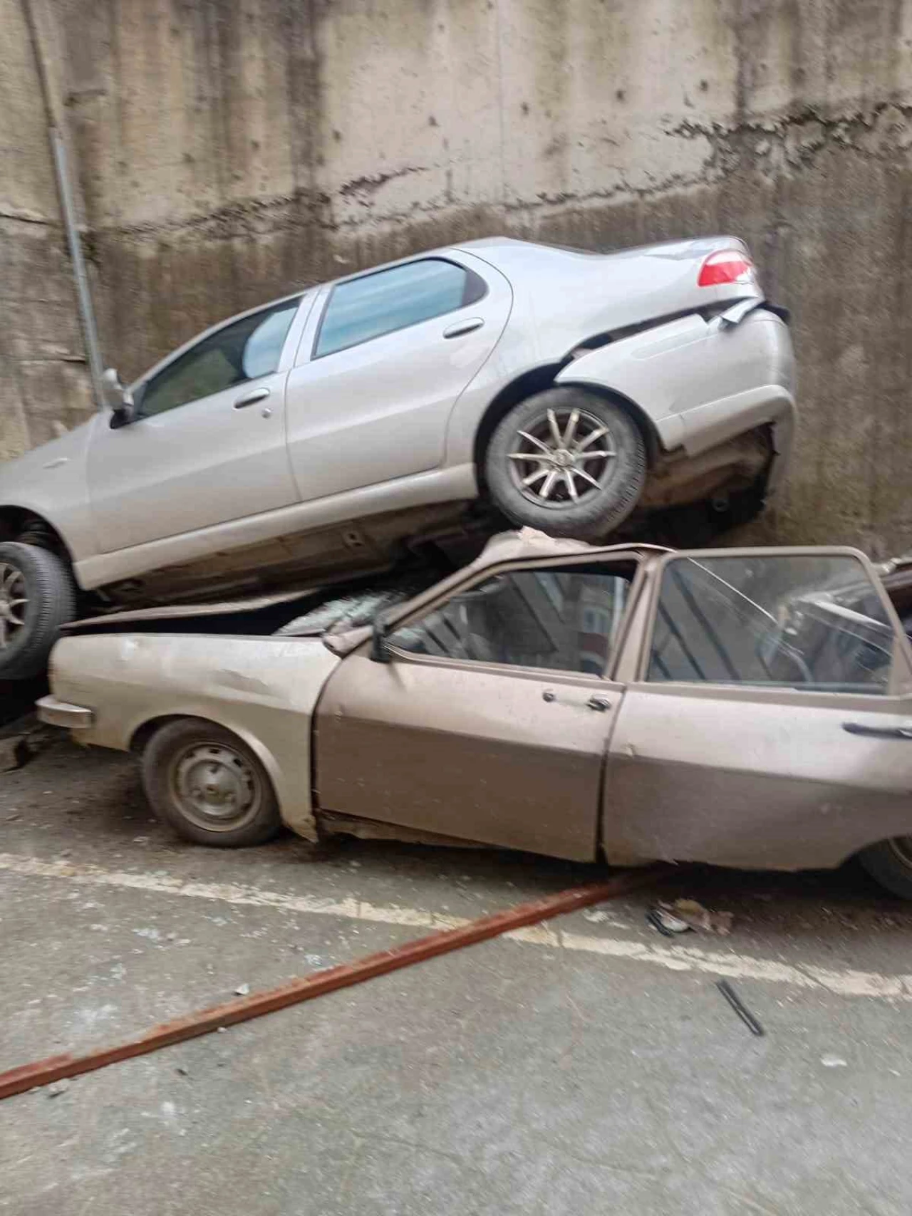 Rampada geriye kayan otomobil 8 metreden düşerek park halindeki aracın üzerine çıktı