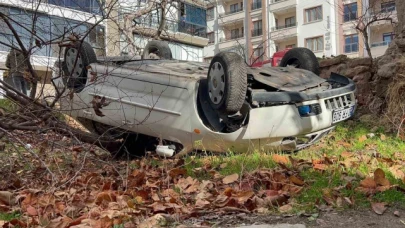 Takla atıp bahçeye düşen otomobilden burnu kanamadan kurtuldu